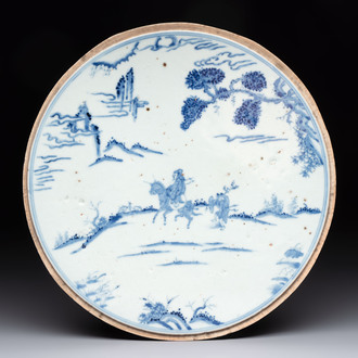 A Chinese blue and white circular plaque with two figures in a landscape, 19/20th C.