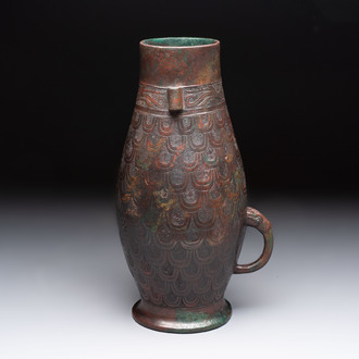 A Chinese archaic bronze inscribed wine vessel with scale design, 'hu 壺', Zhou