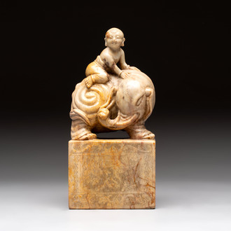 A Chinese soapstone carving of a boy riding an elephant, 20th C.