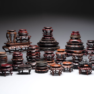 A collection of 45 Chinese wooden stands, 19/20th C.