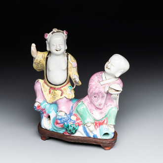 A Chinese famille rose 'Hehe Erxian' group on a wooden stand, Qianlong