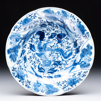 A Chinese blue and white lobed 'phoenix and monkey' plate, flower mark, Kangxi