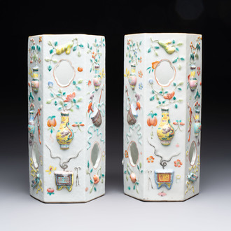 A pair of Chinese famille rose relief-moulded reticulated 'antiquities' hat stands, 19th C.