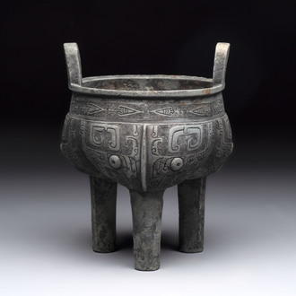 A Chinese archaic bronze tripod food vessel with 'taotie' design, 'ding 鼎', Western Zhou