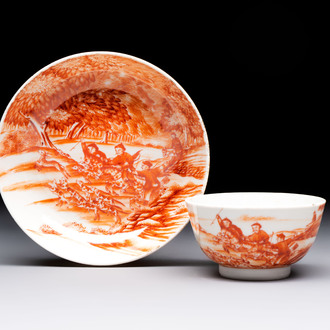 A Chinese iron-red-decorated 'Deer Hunting' cup and saucer, Qianlong