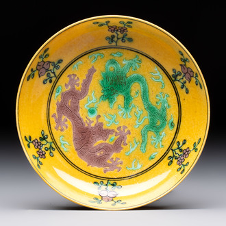 A Chinese yellow-ground aubergine and green-enamelled 'dragon' saucer, Daoguang mark and of the period
