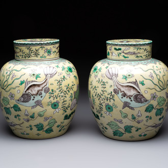 A pair of Chinese verte biscuit 'fish' jars and covers, 19th C.