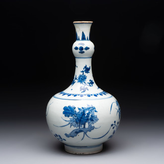 A Chinese blue and white bottle vase with floral design, Transitional period