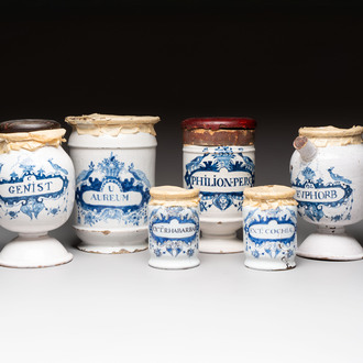 A varied collection of five blue and white faience pharmacy jars and a wet drug jar, Delft, Brussels and Lille, 18th C.