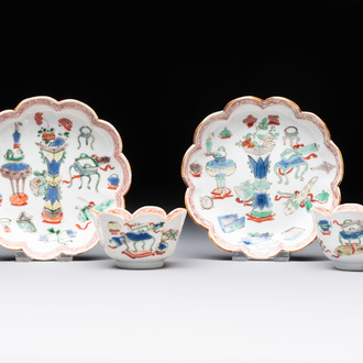 A pair of Chinese famille verte cups and saucers with antiquities, Kangxi