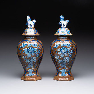 A rare pair of blue and white Dutch Delft brown-ground vases and covers, 18th C.