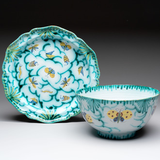 A large polychrome Brussels faience bowl and stand with butterfly and peacock design, 18th C.