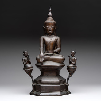 A large and fine Burmese bronze Buddha with two servants, 16/17th C.