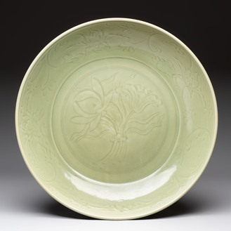 A rare and large Chinese Longquan celadon 'lotus bouquet' dish, Ming, early 15th C.