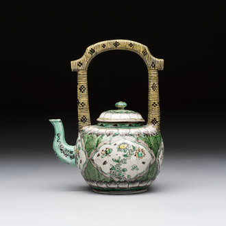 A Chinese verte biscuit teapot and cover with floral design, Kangxi