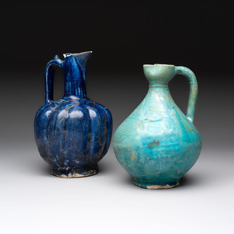 A Kashan turquoise-glazed ewer and a Nishapur blue-glazed ewer, Iran, 12th C.
