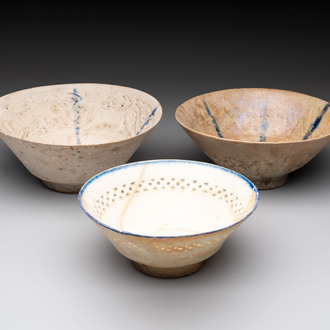 Three Kashan blue and white pierced pottery bowls, Iran, 12/13th C.