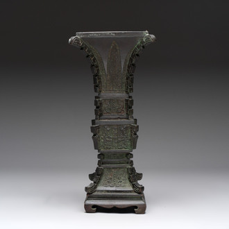 A Chinese archaistic bronze 'gu' vase and stand, Qing
