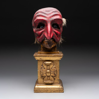 An Italian masked 'petrified' head on giltwood base, mixed media, 19/20th C.