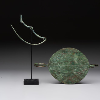 A large bronze Etruscan bow-shaped fibula and a Hungarian fibula with spring clasp, 12/7th C. B.C.