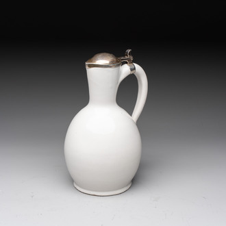 A fine white-glazed Delftware jug with silver cover, 17th C.