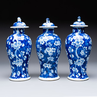 Three Chinese blue and white 'plum blossom' vases and covers, Kangxi mark, 19th C.