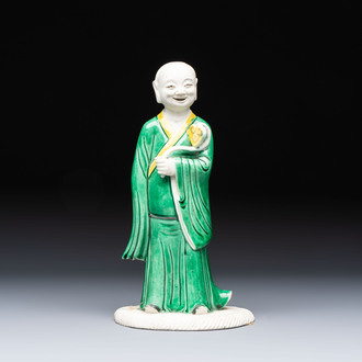 A Chinese verte biscuit Luohan holding a ruyi, Kangxi