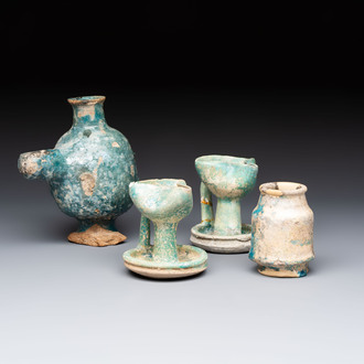 A small turquoise-glazed albarello and three oil lamps, Iran or Syria, 12/13th C.