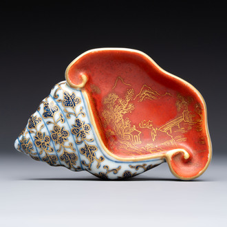 A Chinese blue, white and iron-red gilt-decorated conch-form ink palette with landscape design, Jiaqing mark and of the period