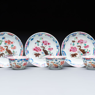 Three Chinese famille rose cups and saucers with a duck among flowering branches, Yongzheng/Qianlong