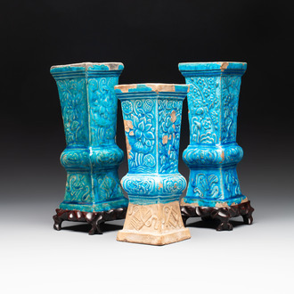 Three Chinese turquoise-glazed square 'gu' vases with floral design and two wooden stands, Ming