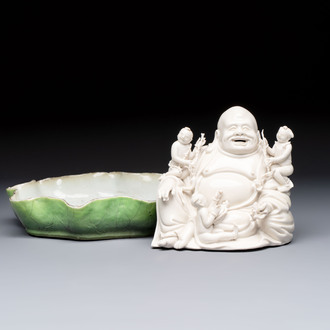 A Chinese green-enamelled lotus leaf-shaped brush washer and a Dehua blanc de Chine Milefo Buddha, 19th C
