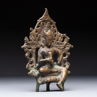 A Tibetan or Nepalese bronze seated Tara holding a vajra, 12/13th C.