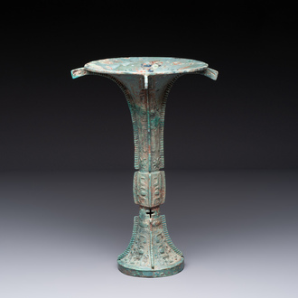 A Chinese archaic bronze wine vessel with 'taotie' design, 'gu 觚', Shang