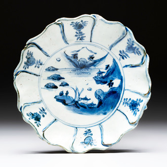A Chinese blue and white ko-sometsuke flower-shaped tripod 'landscape' plate for the Japanese market, late Ming