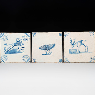 Three blue and white Dutch Delft tiles with a lion, a butterfly and a deer, 17th C.