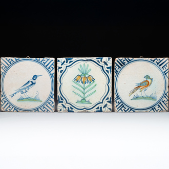 Three polychrome Dutch Delft 'flower' and 'bird' tiles, 17th C.