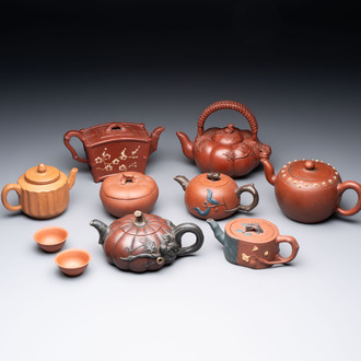 Seven Chinese Yixing stoneware teapots, two cups and a covered box, 20th C.