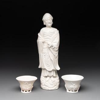 Two Chinese Dehua blanc de Chine wine cups and a figure of Liuhai, 18/19th C.