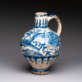 A blue and white Portugese faience jug with a bird among flowering branches, 17th C.
