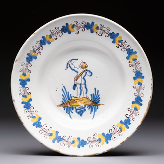 A rare polychrome Dutch Delftware 'Compendario' dish with an arching putto, probably Verstraeten workshop, Haarlem, 17th C.