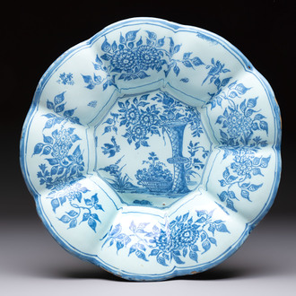 A blue and white Dutch Delft dish with a Chinese 'Gu' vase and a flower basket, 17th C.