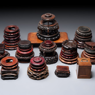 A collection of 38 Chinese wooden stands and a box, 19/20th C.