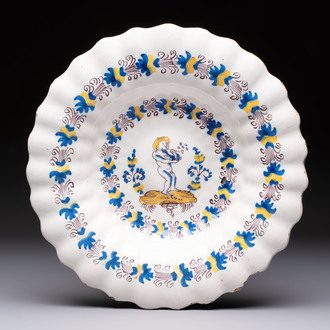 A polychrome lobed Dutch Delftware dish with a putto smoking a pipe, probably Verstraeten workshop, Haarlem, 17th C.