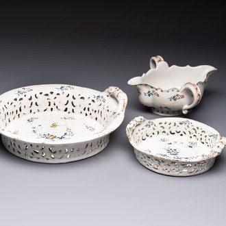 Two reticulated Brussels faience 'A la Haie Fleurie' baskets and a sauce boat, 18th C.
