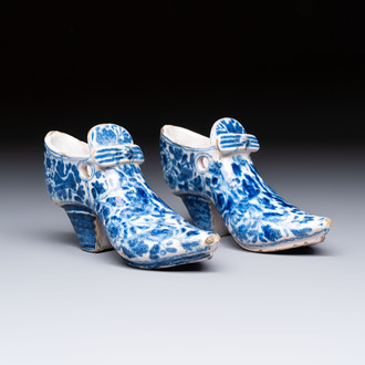 A pair of blue and white Delftware shoes with floral design, France, 18th C.