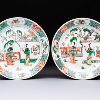 A pair of Chinese famille verte 'Ladies in a Garden' plates, Kangxi