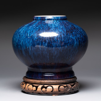 A Chinese flambé-glazed vase on a wooden stand, 19th C.