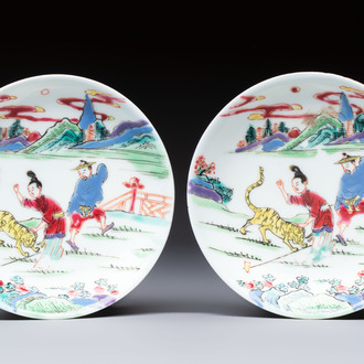 A pair of Chinese famille rose 'Taming the Tiger' saucers, Yongzheng