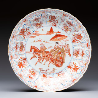 A Chinese iron-red and gilt-decorated dish with a courtly carriage scene, Kangxi